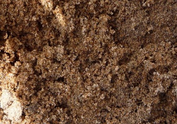 Мытый песок — это карьерный песок природного происхождения. Он добывается в песчаных карьерах открытым способом и промывается водой для повышения качества. Во время промывки из него вымываются глина, камни и другие примеси, в результате чего содержание посторонних частиц в намывном песке не превышает 0,5%. Зерна в таком песке гладкие, имеют округлую форму, по происхождению это чаще всего природный кварц. Чистый кварцевый песок применяют в производстве стекла. Из-за высокой чистоты карьерный мытый песок принято использовать в детских песочницах и дизайнерских ландшафтных проектах, а также для изготовления предметов интерьера — уникальных художественных работ. Однако это не отменяет востребованность песка намывного в качестве отделочного и строительного материала.
